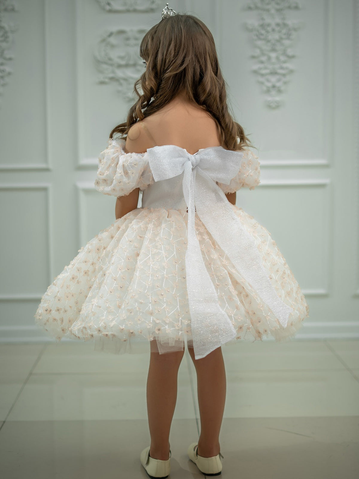 Ivory tulle girls princess dress back view with big glitter tulle bow and flower appliqué tutu skirt, designed for weddings.