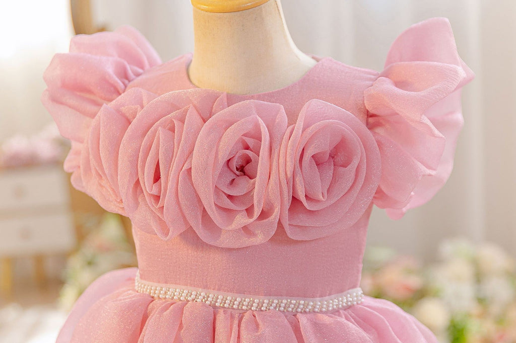 Close-up of the 3D fabric roses across the neckline and flutter sleeves.