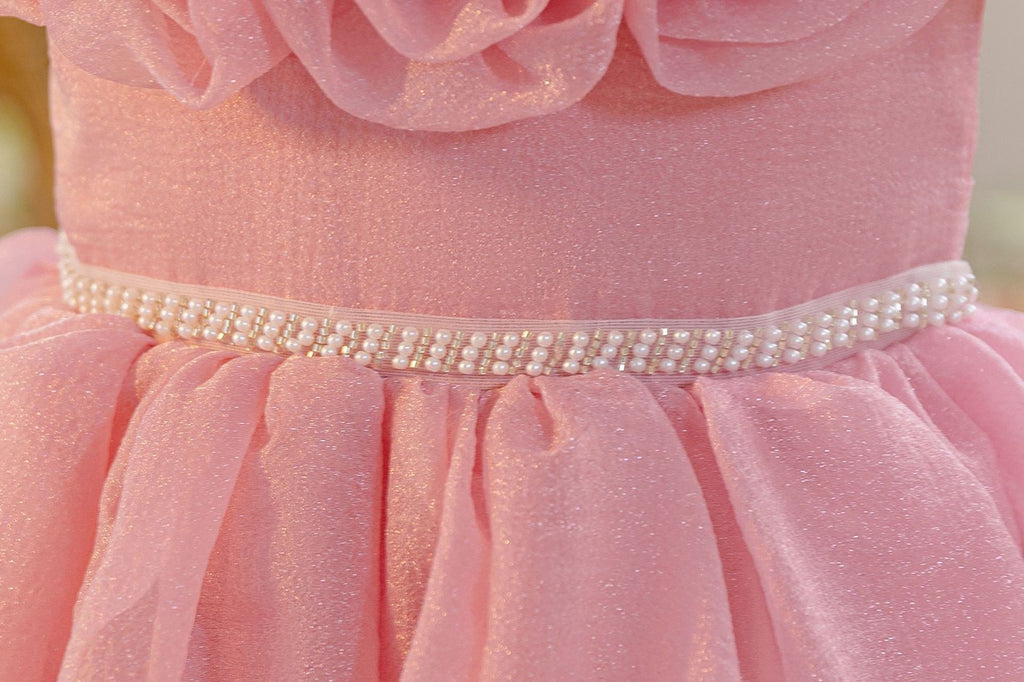 Close-up of the pearl belt at the waist of the dusty rose girls formal dress.