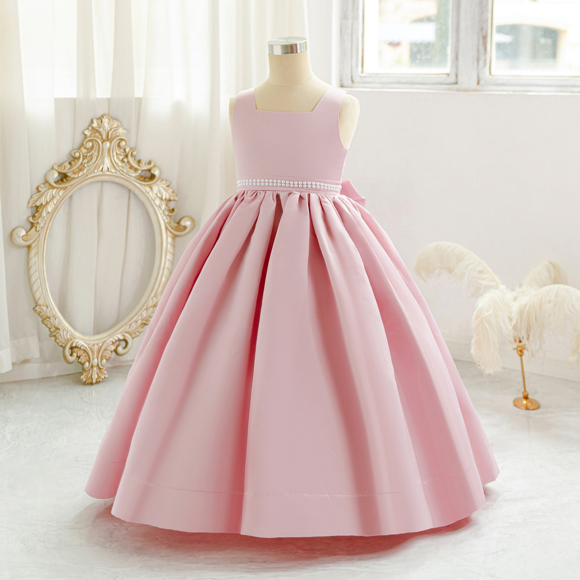 Pink long tulle flower girl dress with bow details