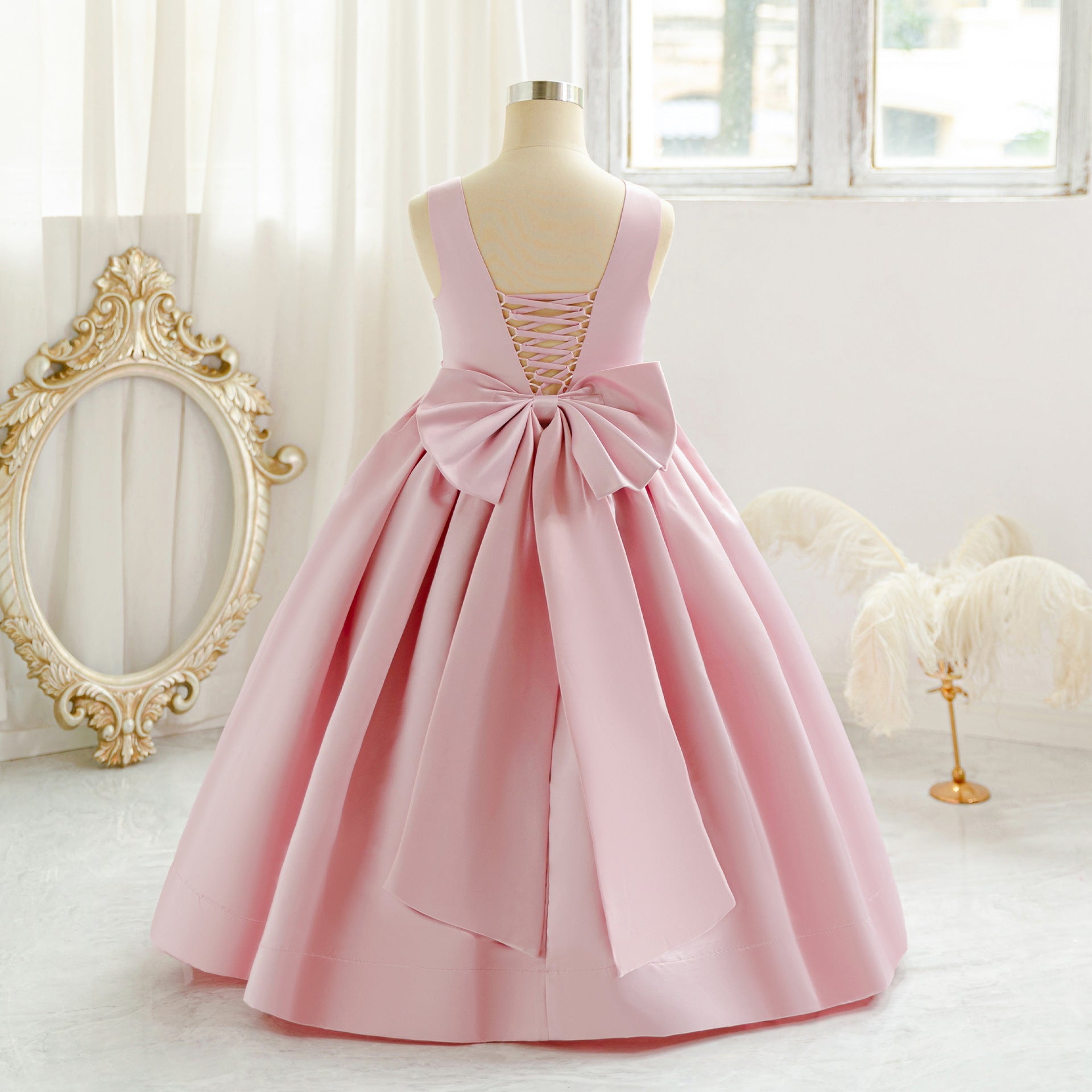 Pink long tulle flower girl dress with bow details