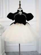 Black velvet girls dress with pearl strand, puff sleeves and ivory tulle tutu skirt, designed for birthday parties.