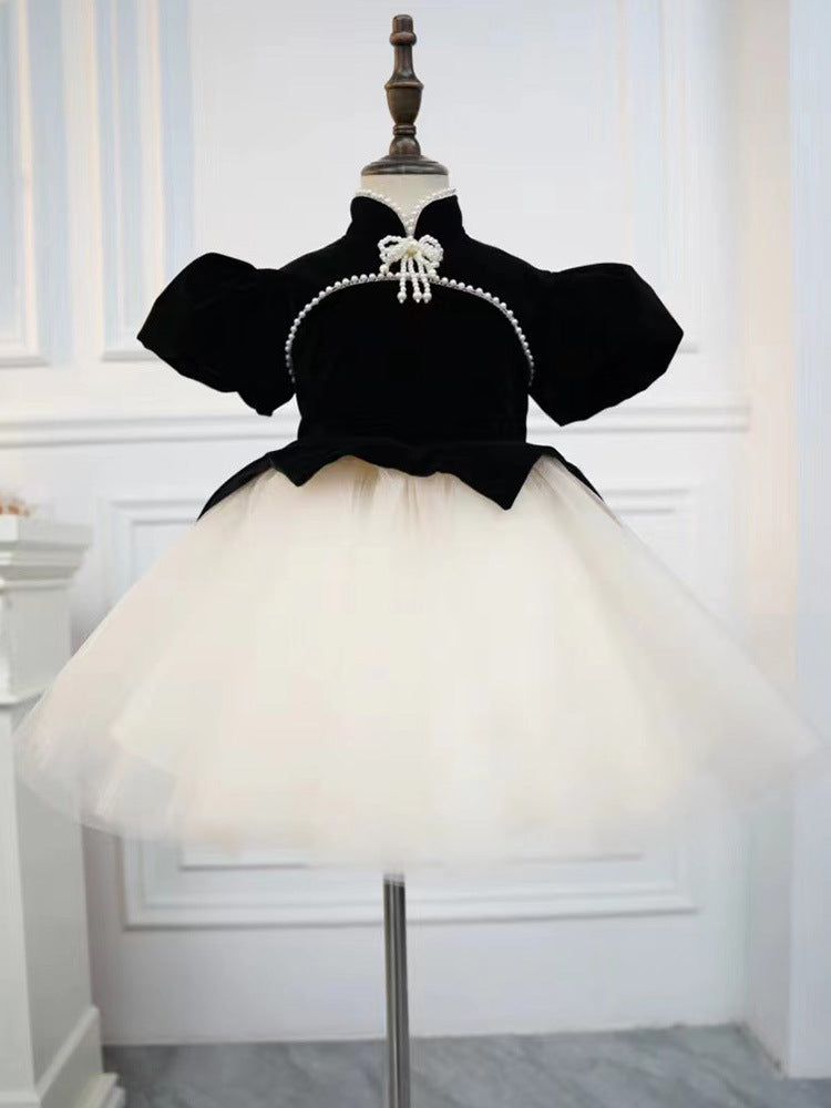 Black velvet girls dress with pearl strand, puff sleeves and ivory tulle tutu skirt, designed for birthday parties.