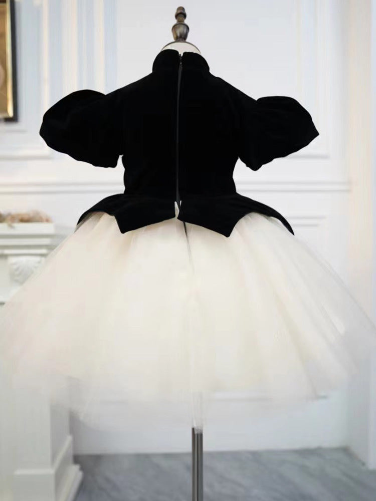 Back view of a black and ivory velvet girls dress with zipper and tulle tutu skirt, designed for birthday parties.