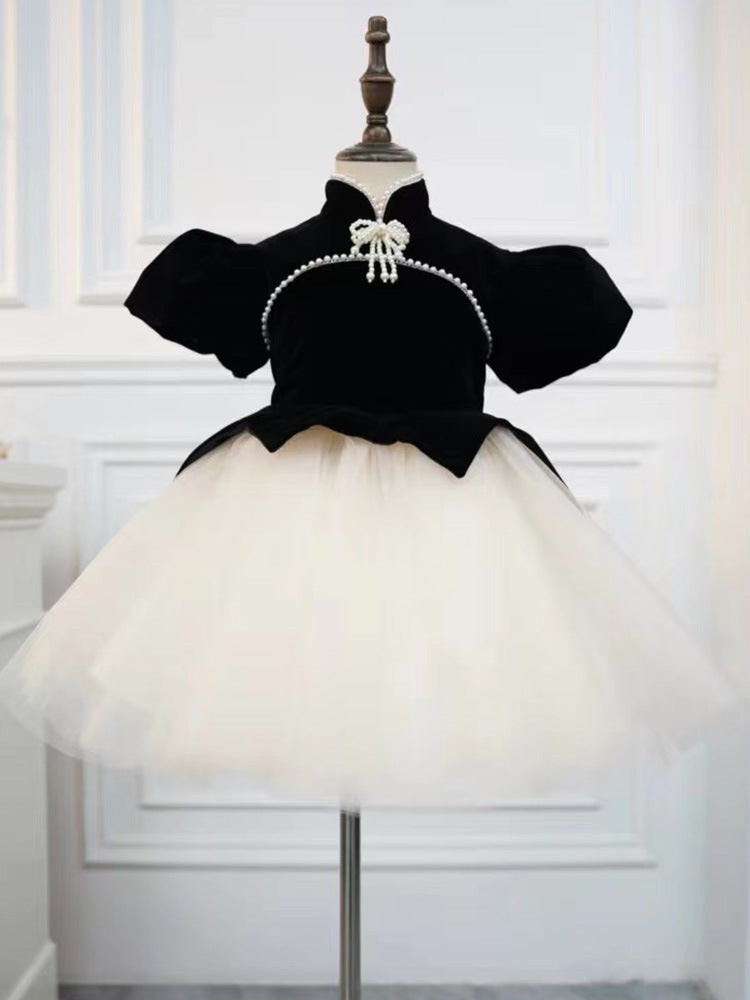 Black and ivory velvet girls dress with pearl bow collar and full tulle skirt, designed for birthday parties and photoshoots.