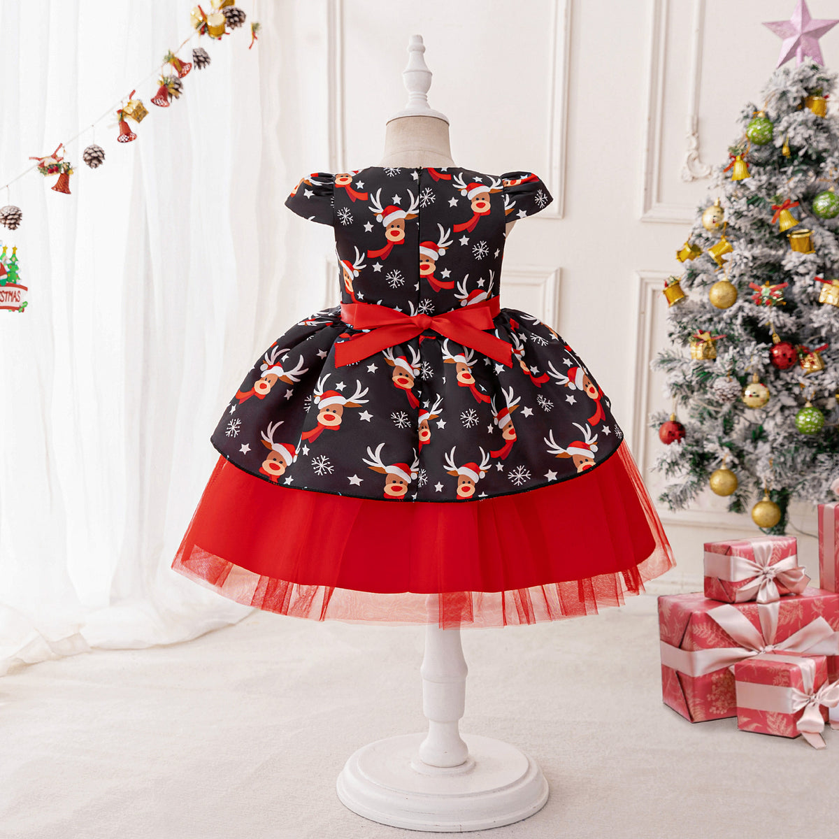 Black and red girls dress with reindeer print bodice, bow peplum and red tulle skirt, designed for Christmas parties, view 4