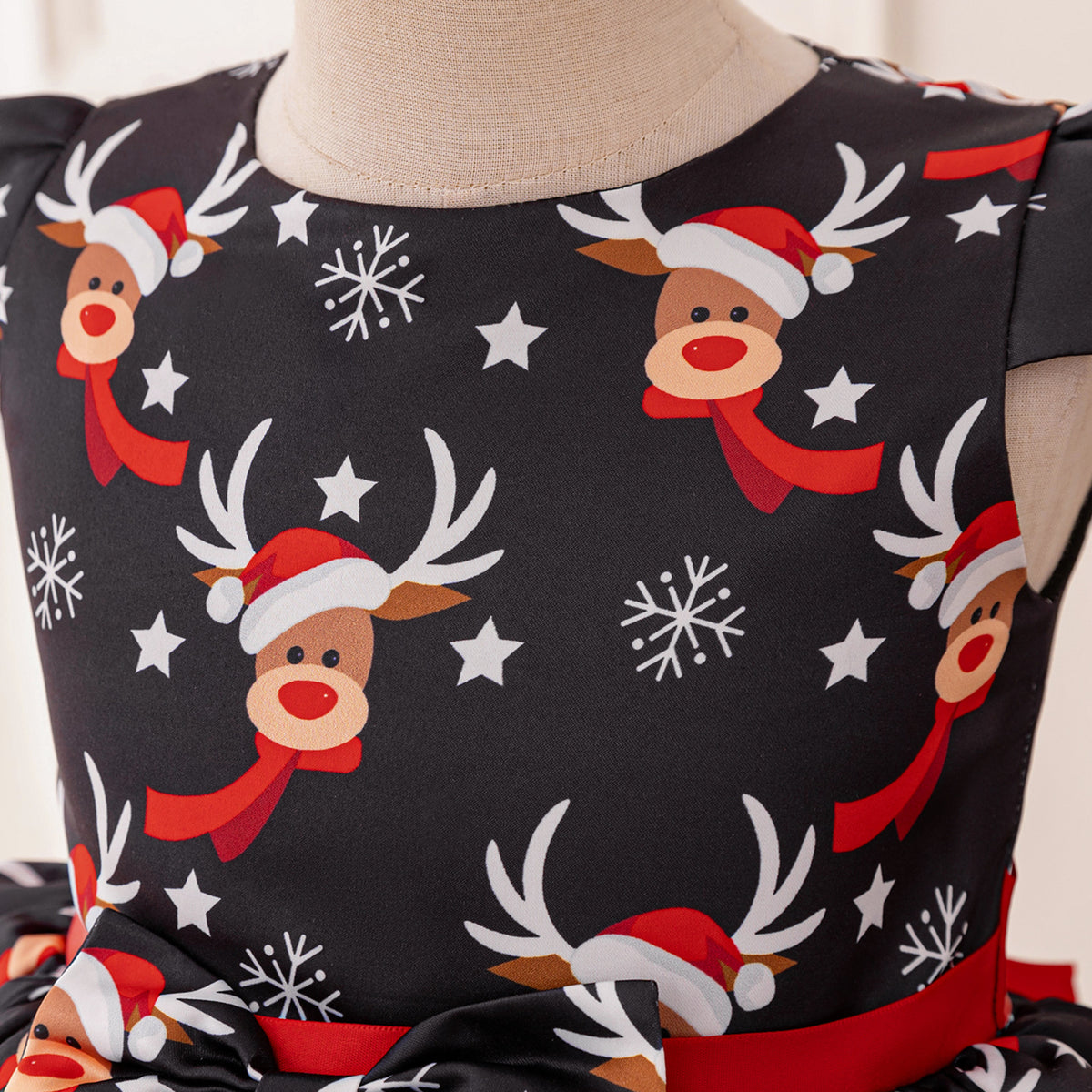 Black and red girls dress with reindeer print bodice, bow peplum and red tulle skirt, designed for Christmas parties, view 5