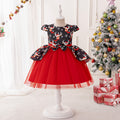 Black and red girls dress with reindeer print bodice, bow peplum and red tulle skirt, designed for Christmas parties.