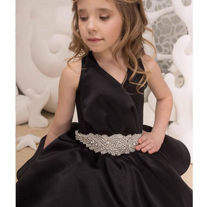 Close-up of the rhinestone beaded belt and the V neckline on the black satin gown.