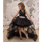Black satin girls formal dress with a rhinestone belt and a high-low organza skirt, front view, for a performance.