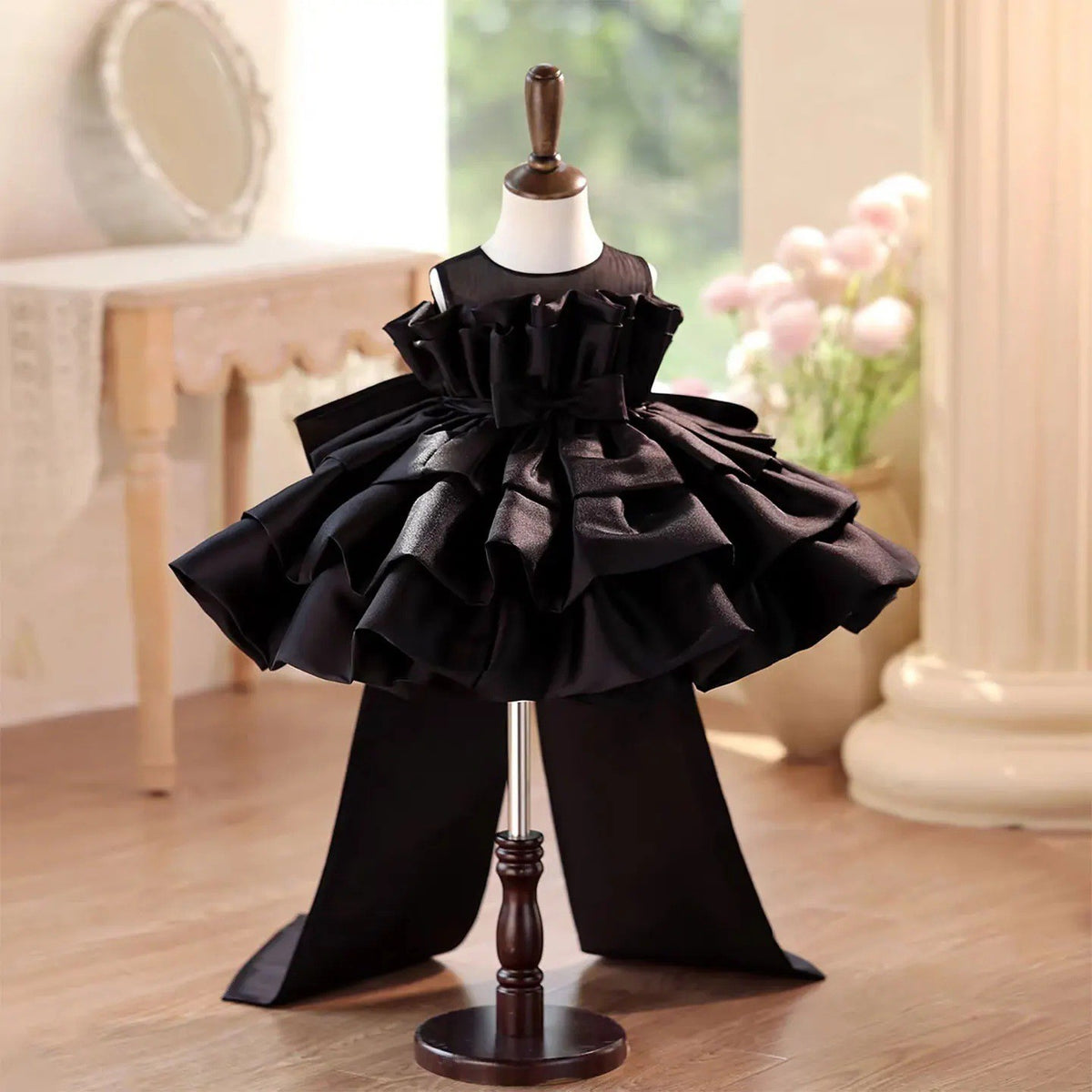 Black satin girls party dress with a ruffle collar and tiered cake skirt, front view, for a birthday party.
