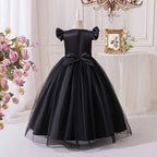 Back view of the black party dress showing the satin bow at the waist.