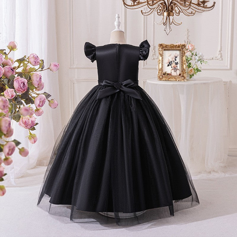 Back view of the black party dress showing the satin bow at the waist.