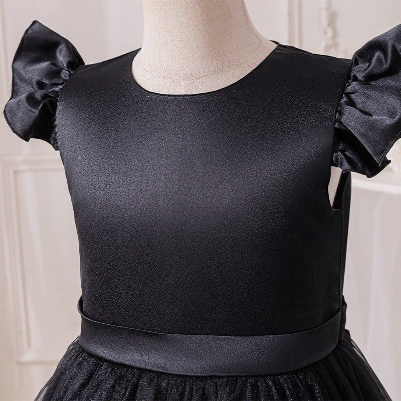 Close-up of the satin bodice, round neckline and flutter sleeve on the black girls dress.