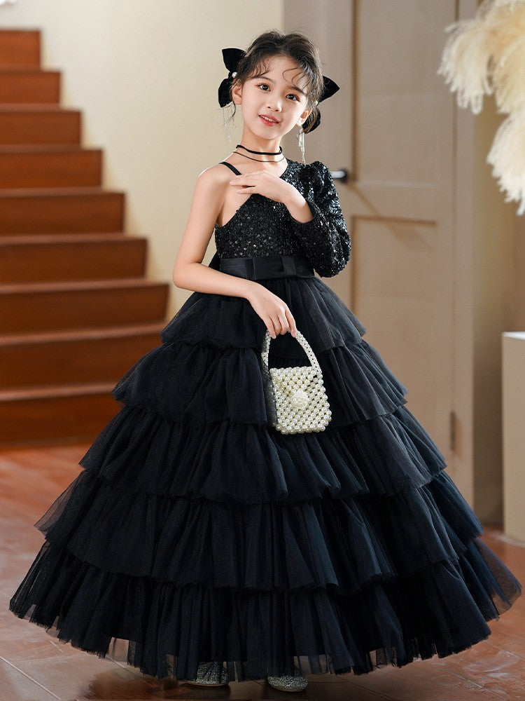 Black sequin girls formal dress with one long sleeve and a tiered tulle skirt, front view, for a pageant.