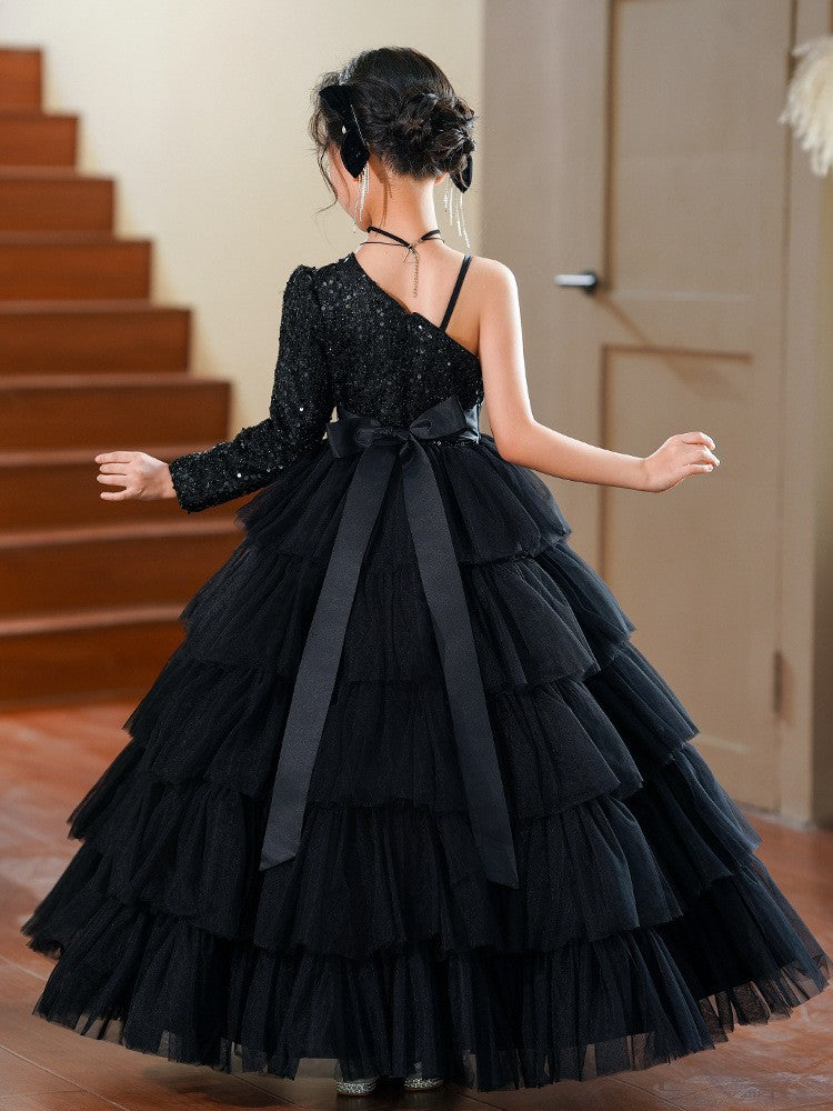 Black dress for girls showing the satin sash bow at the waist, back view.