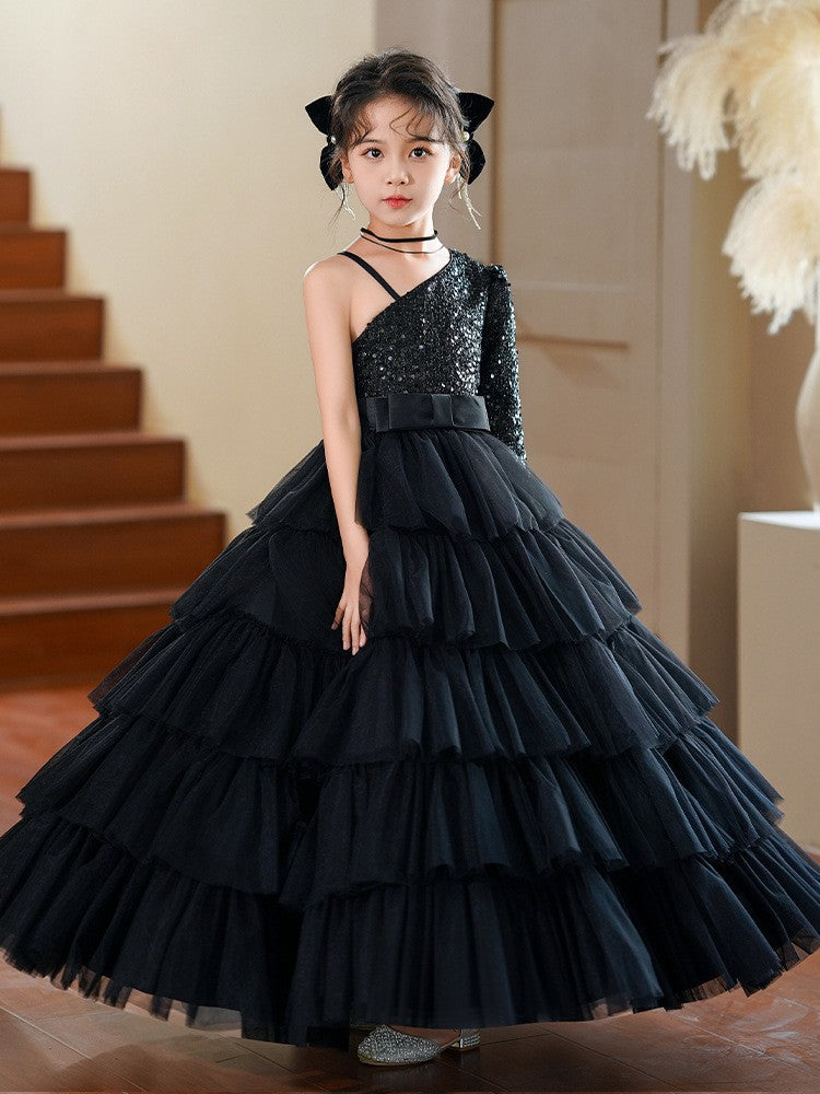 One shoulder black sequin gown with layered tulle ruffles, angled view, for a stage performance.