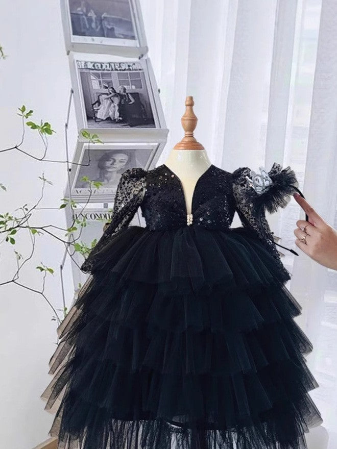 Tiered tulle skirt on the black sequin girls party dress, side view, for a stage performance.