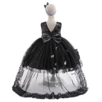Back view of the black sequin tulle girls gown with V-back, oversized sequin bow and sheer ruffled train, designed for Halloween parties.