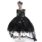 Side view of the black sequin tulle girls gown with high-low skirt and ruffled train, designed for Halloween and birthday parties.