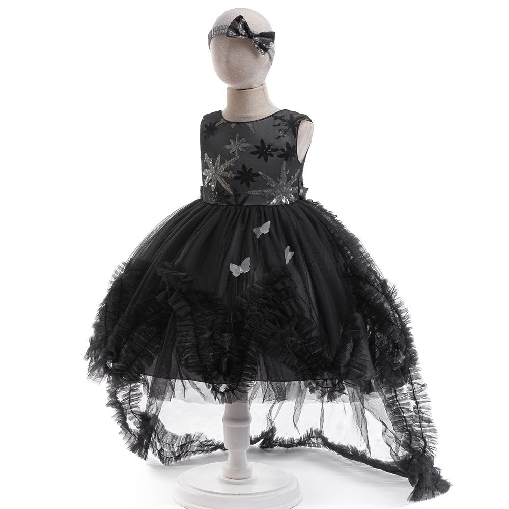 Side view of the black sequin tulle girls gown with high-low skirt and ruffled train, designed for Halloween and birthday parties.