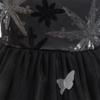 Close-up of the sequin bodice, fitted waist and layered black tulle skirt with a sheer butterfly appliqué.