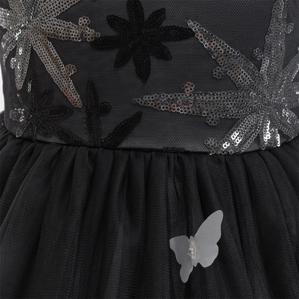 Close-up of the sequin bodice, fitted waist and layered black tulle skirt with a sheer butterfly appliqué.