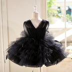 Black tulle princess dress for girls showing the V-back with a concealed zipper, back view, styled for a photoshoot.