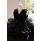 Close-up of the pleated tulle bodice and the ruffled skirt tiers on the black tulle girls party dress.