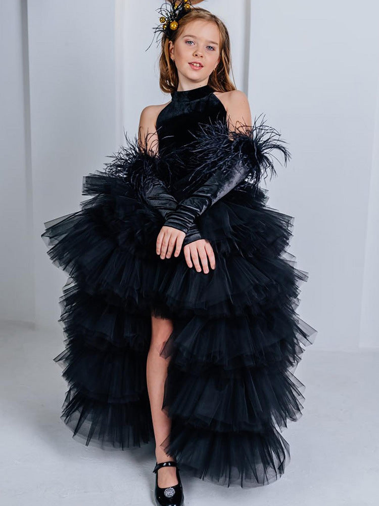 Black velvet girls tulle gown with halter neck, bow open back and tiered high-low ruffle skirt, designed for birthdays and pageants.
