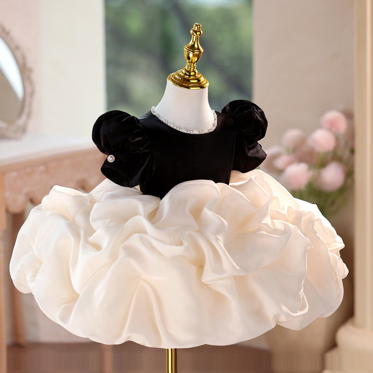 Black velvet and ivory organza birthday girls dress with short puff sleeves, front view, for a birthday party.