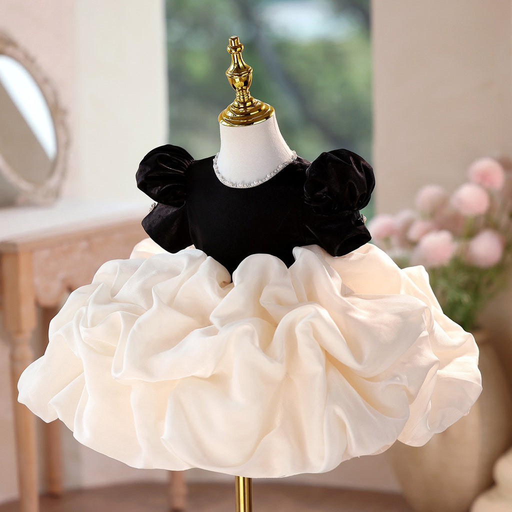 Ivory organza bubble skirt under the black velvet bodice, side view, for a holiday party.