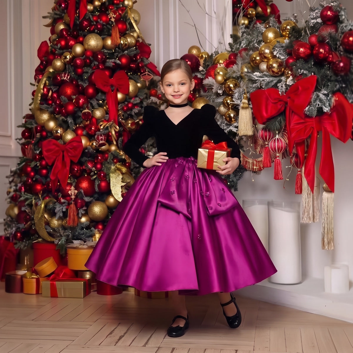 Girls Christmas dress with black velvet bodice and magenta satin skirt with beaded bow, girl holding a gift by a Christmas tree