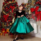 Black and green velvet and satin girls dress with beaded flowers and hip bow, designed for Christmas parties.