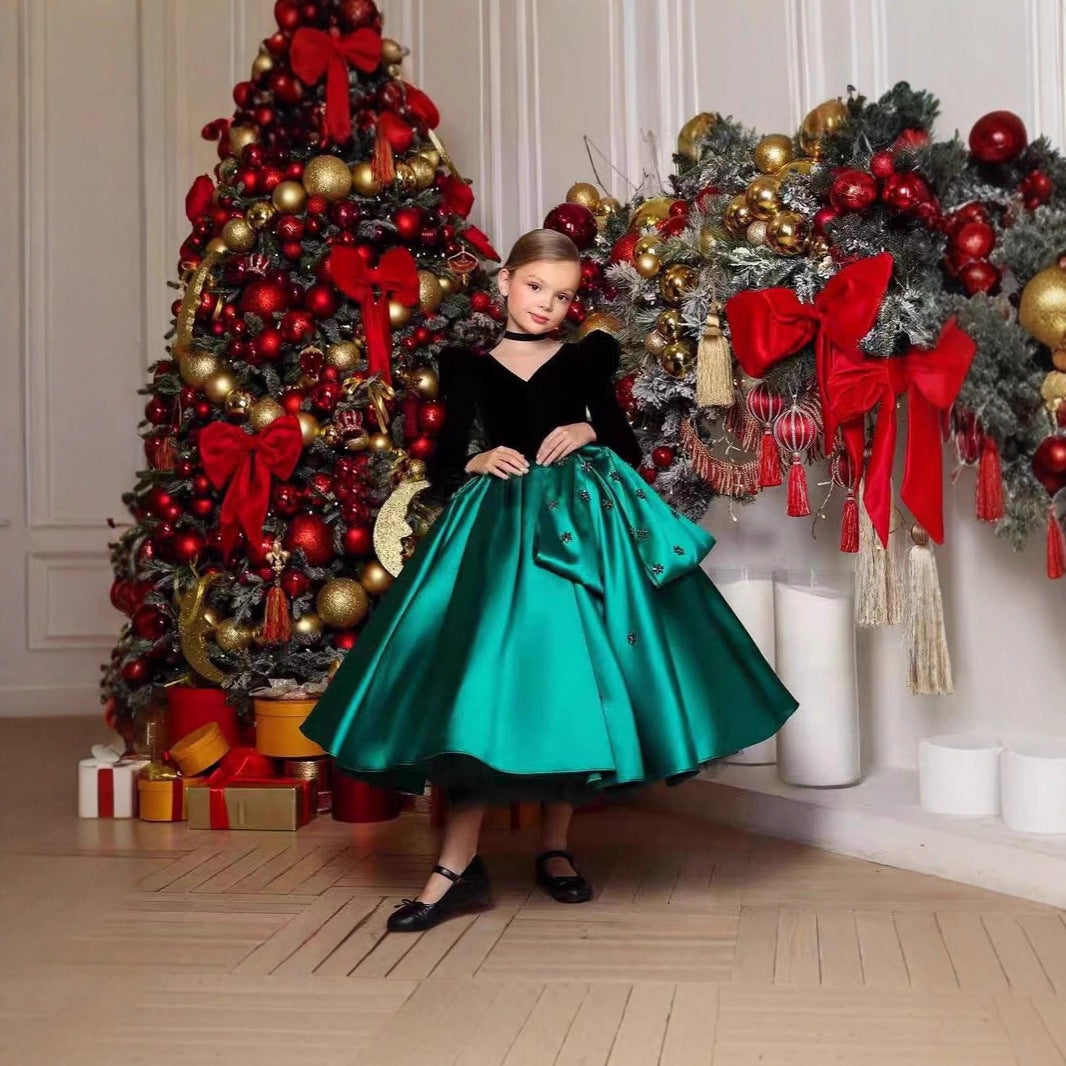 Black and green velvet and satin girls dress with long puff sleeves, beaded flowers and hip bow, designed for Christmas parties.