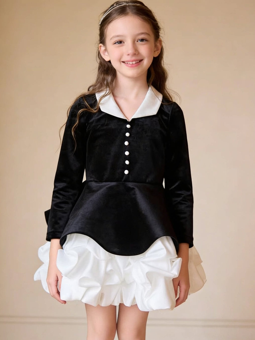 Black and white velvet girls dress with scalloped peplum and pearl buttons, designed for holiday parties.