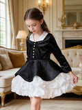 Black and white velvet girls dress with white collar, pearl buttons, peplum and bubble skirt, designed for recitals and parties.