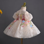 Back view of the blush floral girls birthday dress showing the concealed back zip and embroidered bodice.