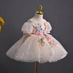 Blush sequin tulle girls party dress styled with fresh flowers, full front view, for birthday parties and photoshoots.