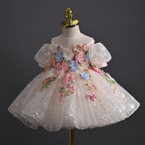 Blush sequin tulle girls party dress with embroidered flowers and a full ball gown skirt, side angle view.