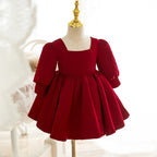 Burgundy satin girls holiday dress styled with feather wings, front view, for birthday and Christmas photoshoots.