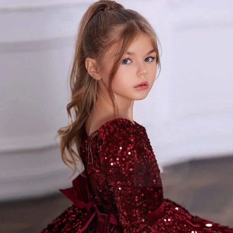 Burgundy sequin girls party dress with long sleeves, angled side view, for a piano recital.