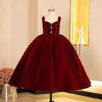 Burgundy velvet flower girl dress with a rhinestone sweetheart bodice and a full ball gown skirt, front view, for winter weddings.