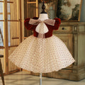 Burgundy velvet girls dress with open back, sheer dotted bow and champagne dotted tulle skirt, designed for Christmas parties.