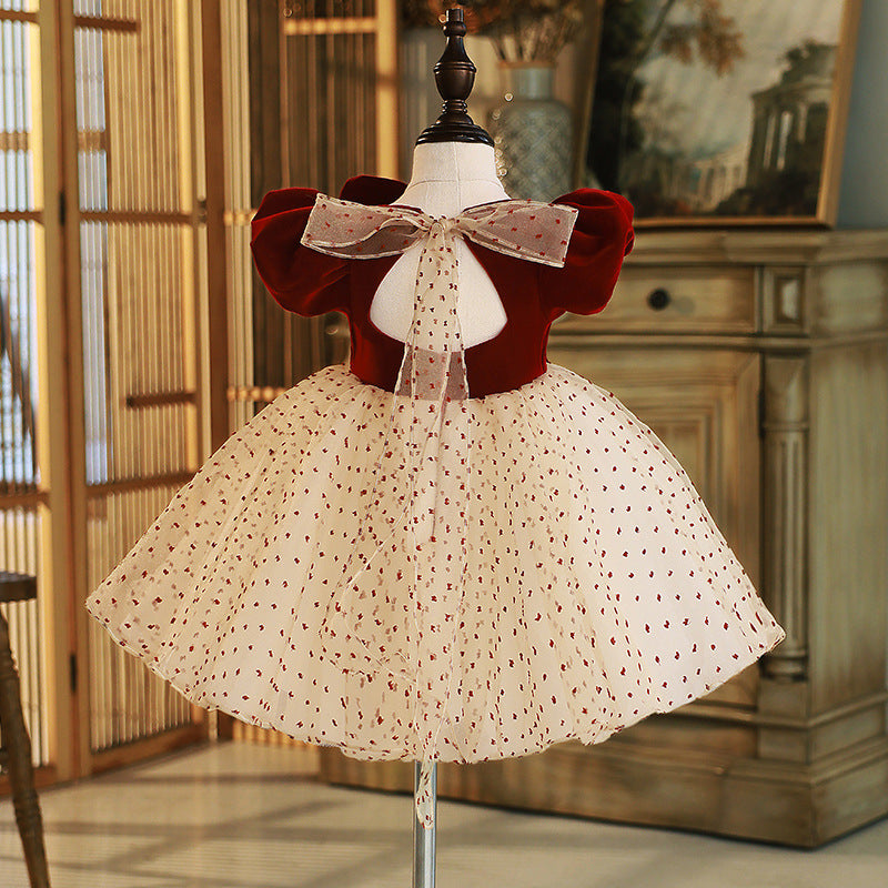 Burgundy velvet girls dress with open back, sheer dotted bow and champagne dotted tulle skirt, designed for Christmas parties.