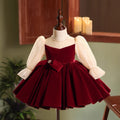 Burgundy velvet girls dress with champagne lace puff sleeves, pearl-center bow and full knee-length skirt, designed for Christmas and holiday parties.