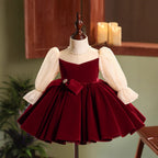 Burgundy velvet girls dress with champagne lace puff sleeves, pearl-center bow and full knee-length skirt, designed for Christmas and holiday parties.