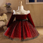 Burgundy velvet girls dress back view with long sleeves and a full sparkle tulle skirt, designed for holiday parties.