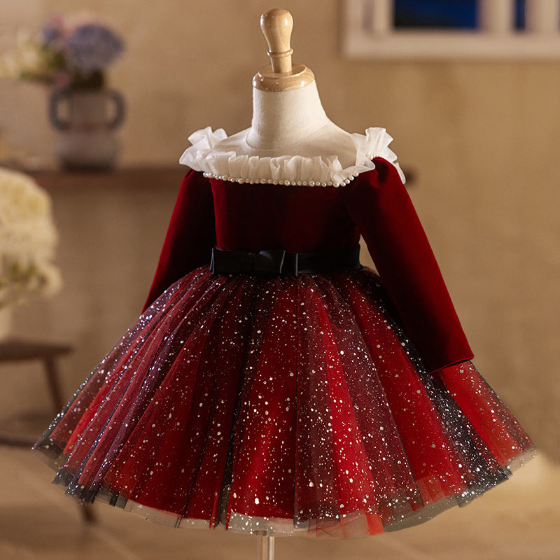 Burgundy velvet girls party dress with an ivory ruffle neckline, long sleeves and a full sparkle tulle skirt, designed for Christmas and birthdays.