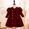 Burgundy glitter velvet girls party dress with a V-neck bodice, long puff sleeves and crystal flower buttons, front view, for birthday parties.
